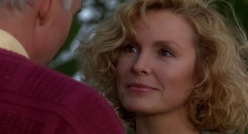 Movie still from “L.A. Story” (1991), directed by Mick Jackson – A person with curly blonde hair; Close Up shot, Over the shoulder angle
