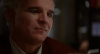 Movie still from “L.A. Story” (1991), directed by Mick Jackson – A man's face in a dark room; Close Up shot, Low angle