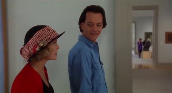 Movie still from “L.A. Story” (1991), directed by Mick Jackson – A man standing next to a woman wearing a hat; Close Up shot, Low angle