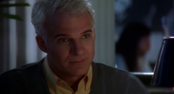 Movie still from “L.A. Story” (1991), directed by Mick Jackson – A person wearing a yellow button up shirt; Close Up shot, Over the shoulder angle