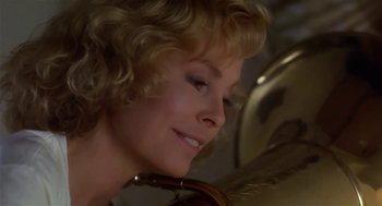 Movie still from “L.A. Story” (1991), directed by Mick Jackson – A person with a violin; Close Up shot, Low angle