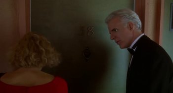 Movie still from “L.A. Story” (1991), directed by Mick Jackson – A man and a woman standing next to each other in a room; Close Up shot, Low angle