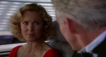 Movie still from “L.A. Story” (1991), directed by Mick Jackson – An older man and a younger woman are looking at one another; Close Up shot, Over the shoulder angle