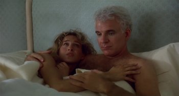 Movie still from “L.A. Story” (1991), directed by Mick Jackson – A man and a woman laying in a bed together; Close Up shot, Low angle