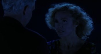 Movie still from “L.A. Story” (1991), directed by Mick Jackson – A man and a woman in a dark room; Close Up shot, Over the shoulder angle