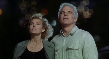 Movie still from “L.A. Story” (1991), directed by Mick Jackson – A man and a woman standing next to each other; Close Up shot, Low angle