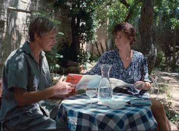 Movie still from “La Belle Noiseuse” (1991), directed by Jacques Rivette – A man and a woman sitting at an outdoor table; Medium shot, High angle