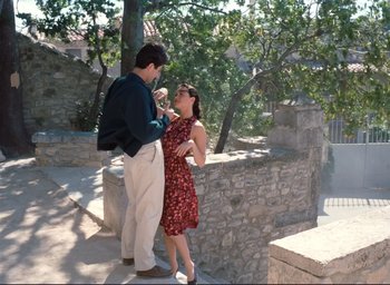 Movie still from “La Belle Noiseuse” (1991), directed by Jacques Rivette – A man and a woman standing next to each other on steps; Wide shot, High angle