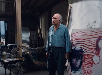 Movie still from “La Belle Noiseuse” (1991), directed by Jacques Rivette – An older man standing in front of a painting; Medium shot, Low angle