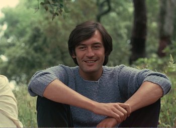 A man sitting on a chair in a forest