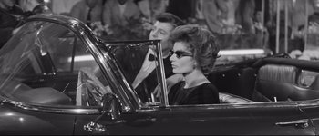 Movie still from “La Dolce Vita” (1960), directed by Federico Fellini – A woman driving a car while talking on the phone; Medium shot, High angle