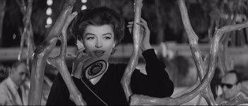 Movie still from “La Dolce Vita” (1960), directed by Federico Fellini – A black and white photo of a woman talking on a phone; Close Up shot, Low angle
