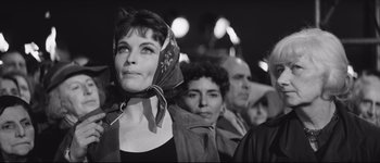 Movie still from “La Dolce Vita” (1960), directed by Federico Fellini – Black and white photograph of a woman in a crowd; Close Up shot, Low angle