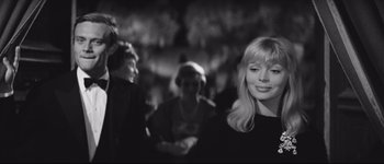 Movie still from “La Dolce Vita” (1960), directed by Federico Fellini – Black and white photograph of a woman in a crowd; Close Up shot, Over the shoulder angle