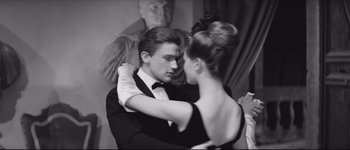 Movie still from “La Dolce Vita” (1960), directed by Federico Fellini – A man and a woman in formal wear dancing; Medium shot, Low angle