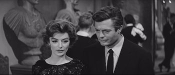 Movie still from “La Dolce Vita” (1960), directed by Federico Fellini – A man and a woman standing next to each other; Close Up shot, Over the shoulder angle