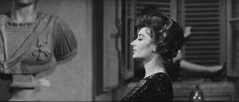 Movie still from “La Dolce Vita” (1960), directed by Federico Fellini – A black and white photo of a woman with her eyes closed; Close Up shot, Low angle