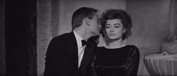 Movie still from “La Dolce Vita” (1960), directed by Federico Fellini – A black and white photo of a man and a woman kissing; Close Up shot, High angle