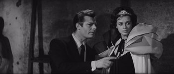 Movie still from “La Dolce Vita” (1960), directed by Federico Fellini – A black and white photo of a man and a woman; Medium shot, Over the shoulder angle