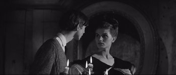 Movie still from “La Dolce Vita” (1960), directed by Federico Fellini – A man and a woman holding lit candles in front of each other; Medium shot, Low angle