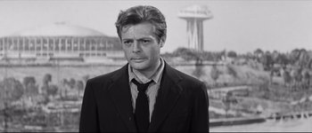 Movie still from “La Dolce Vita” (1960), directed by Federico Fellini – Black and white photograph of a man wearing a suit and tie; Close Up shot, Low angle