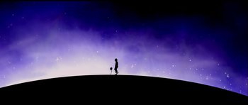 Movie still from “Nikita” (1990), directed by Luc Besson – A person standing on top of a hill holding a soccer ball; Extreme Wide shot, Low angle