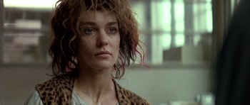 Movie still from “Nikita” (1990), directed by Luc Besson – A person wearing a leopard print jacket; Close Up shot, Low angle