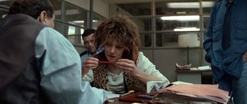 Movie still from “Nikita” (1990), directed by Luc Besson – A woman is holding a pair of chopsticks in her hands; Close Up shot, Over the shoulder angle