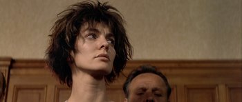 Movie still from “Nikita” (1990), directed by Luc Besson – A man and a woman standing next to each other; Close Up shot, Low angle