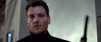 Movie still from “Nikita” (1990), directed by Luc Besson – A person wearing a black shirt; Close Up shot, Low angle