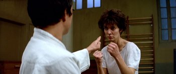 Movie still from “Nikita” (1990), directed by Luc Besson – A man and a woman in front of a mirror; Close Up shot, Over the shoulder angle