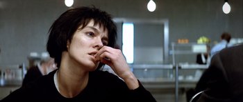Movie still from “Nikita” (1990), directed by Luc Besson – A woman sitting in front of a mirror with her hand under her chin; Close Up shot, Low angle