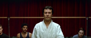 Movie still from “Nikita” (1990), directed by Luc Besson – A man and a woman in a white robe; Close Up shot, Low angle