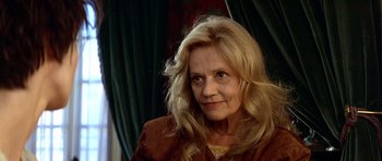 Movie still from “Nikita” (1990), directed by Luc Besson – A person with long blonde hair; Close Up shot, Low angle