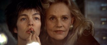 Movie still from “Nikita” (1990), directed by Luc Besson – An older woman and a younger woman are posing for a picture; Close Up shot, Low angle