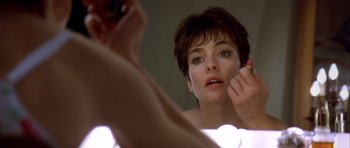 Movie still from “Nikita” (1990), directed by Luc Besson – A person in a mirror putting make up on; Close Up shot, Over the shoulder angle