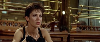 Movie still from “Nikita” (1990), directed by Luc Besson – A person sitting in a room; Close Up shot, Over the shoulder angle