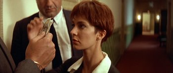 Movie still from “Nikita” (1990), directed by Luc Besson – A person with short red hair; Close Up shot, Low angle