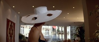 Movie still from “Nikita” (1990), directed by Luc Besson – A woman wearing a white hat and a black top; Close Up shot, Low angle