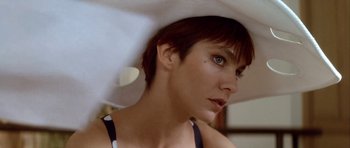Movie still from “Nikita” (1990), directed by Luc Besson – A person with short hair wearing a hat; Close Up shot, Low angle