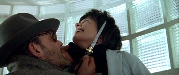 Movie still from “Nikita” (1990), directed by Luc Besson – A man holding a knife over a woman's face; Close Up shot, High angle