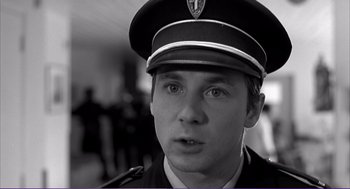 Movie still from “La haine” (1995), directed by Mathieu Kassovitz – A person wearing a uniform; Close Up shot, Low angle