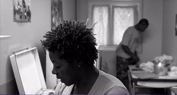 Movie still from “La haine” (1995), directed by Mathieu Kassovitz – A black and white photo of a person with a dreadlocks; Medium shot, Low angle