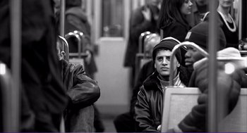 Movie still from “La haine” (1995), directed by Mathieu Kassovitz – A black and white photo of people on a train; Medium shot, Low angle
