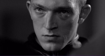 Movie still from “La haine” (1995), directed by Mathieu Kassovitz – Black and white photograph of a man's face; Close Up shot, Low angle