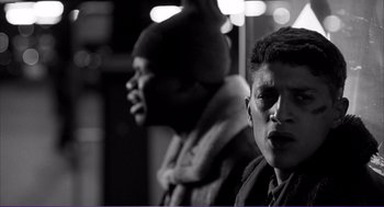 Movie still from “La haine” (1995), directed by Mathieu Kassovitz – Two young men standing next to each other on a bus; Close Up shot, Low angle