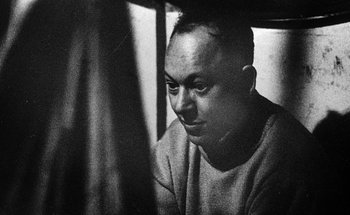 Movie still from “La Jetée” (1962), directed by Chris Marker – Black and white photograph of a man looking at the camera; Close Up shot, Low angle