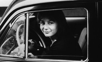 Movie still from “La Jetée” (1962), directed by Chris Marker – A woman sitting in the driver's seat of a car; Close Up shot, High angle