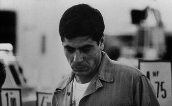 Movie still from “La Jetée” (1962), directed by Chris Marker – Black and white photograph of a man with a beard; Close Up shot, Low angle