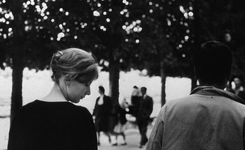 Movie still from “La Jetée” (1962), directed by Chris Marker – A black and white photo of a woman in a black dress; Close Up shot, Over the shoulder angle